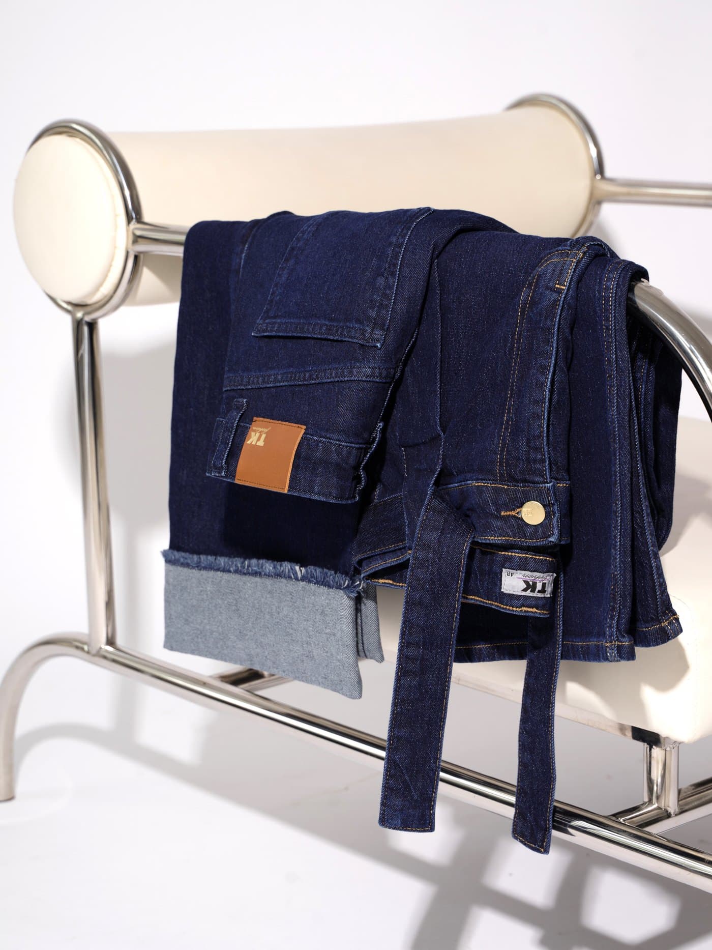 TK Fashion — folded jeans on a chair